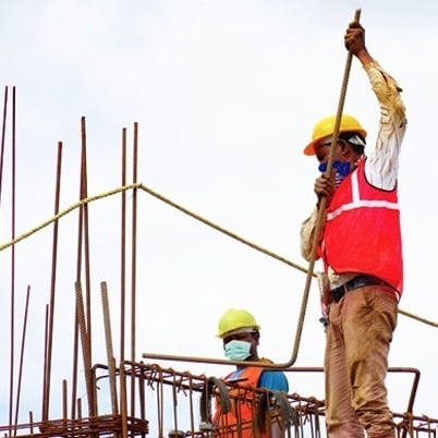 Construction workers at a worksite symbolising labour shortages affecting multiple sectors in India