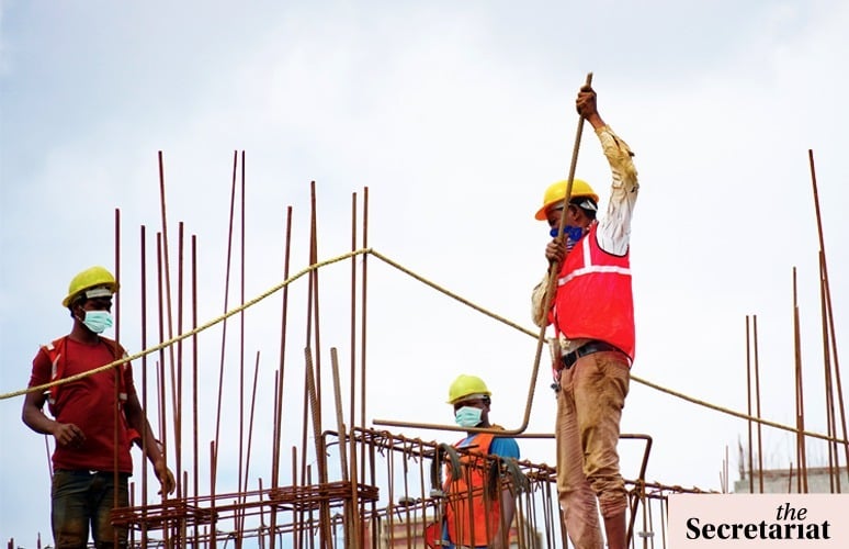 Construction workers at a worksite symbolising labour shortages affecting multiple sectors in India